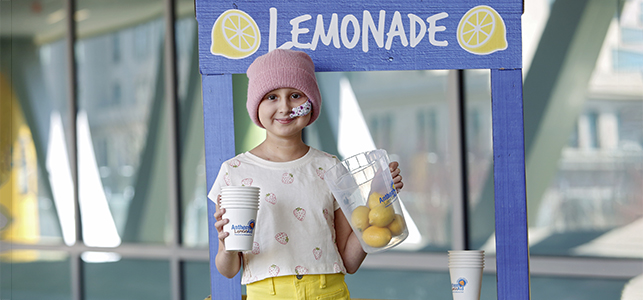 CHoR's 2025 Anthem LemonAid Ambassador Ava Lester holds a pitcher of lemons