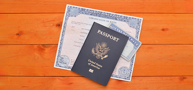 Passport on top of a Social Security card and birth certificate