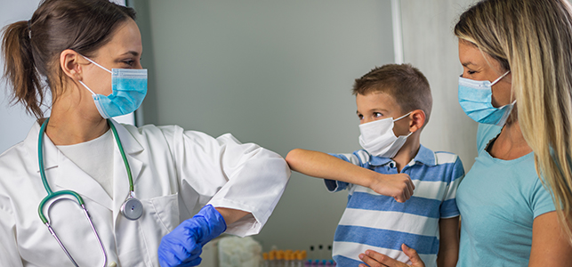 Boy with doctor after COVID vaccine