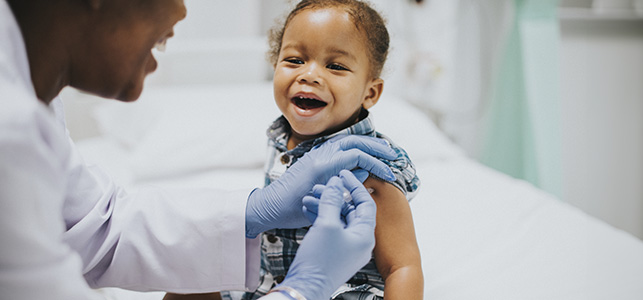 Young child receiving a vaccine in the arm