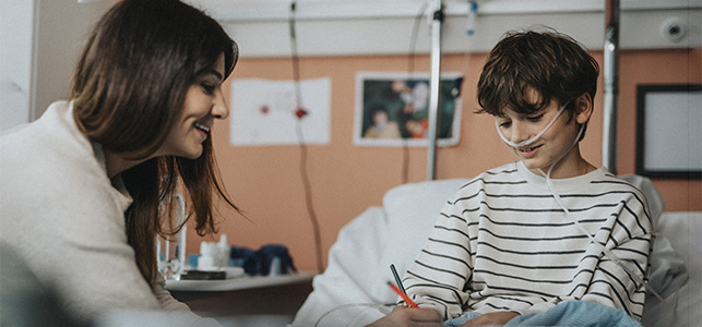 Chaplain talks to a young patient in the hospital
