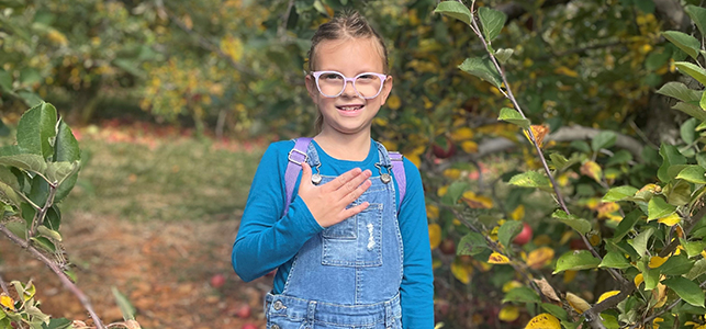 CHoR patient Elizabeth smiling in the apple orchard