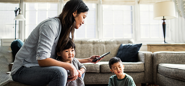 CHoR mom with two kids looking at MyChart on phone