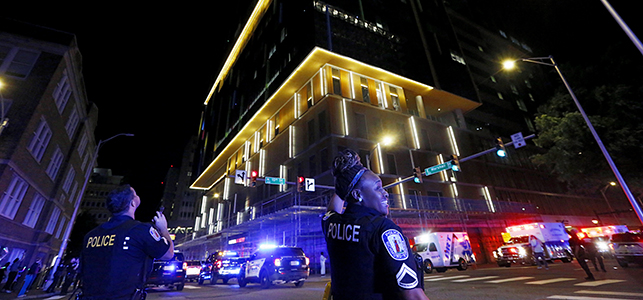 Police officers smile and wave to patients in the Children's Tower during third annual goodnight lights