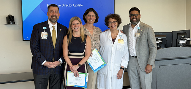 Drs. Tamara Sutherland and Liv Gorla smile with members of CHoR executive leadership