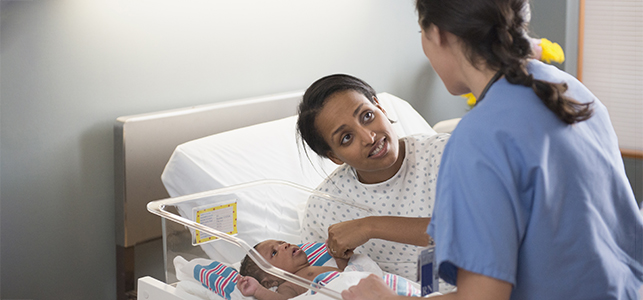 Mom talking to nurse in the hospital with her newborn