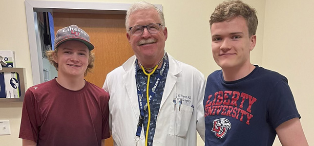 CHoR patients Rocky and David Holsinger smile with surgeon Dr. Frazier Frantz