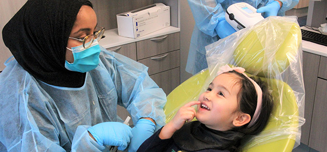Young girl with her dentist in the VCU dental care pediatric clinic