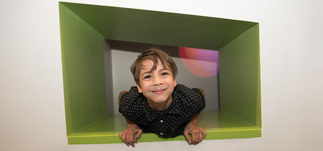 CHoR patient Jonah Smith smiling in a green nook in the Children's Tower