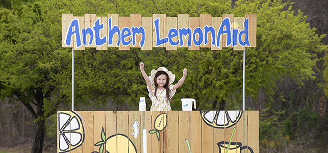 CHoR patient Kyleigh smiles at her Anthem LemonAid stand