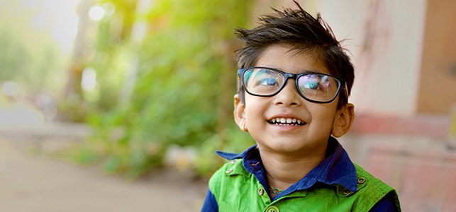 Young boy wearing glasses and smiling