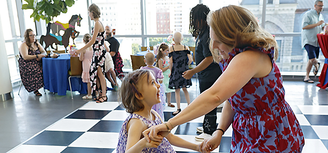 CHoR's Dr. Jordyn Griffin dances with a patient at the 2026 hematology oncology prom