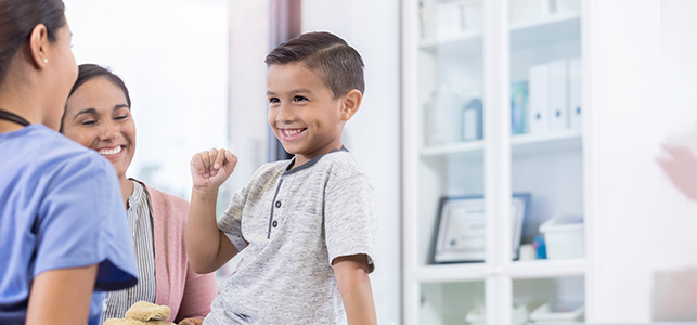 Young boy smiles at his doctor during an appointment