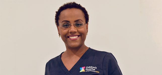Dr. Miheret NICU smiling in navy CHoR scrubs