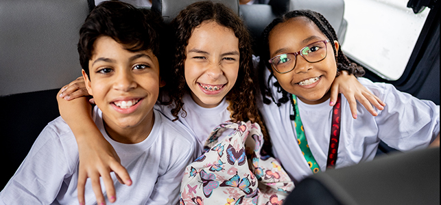 three middle school students on school bus